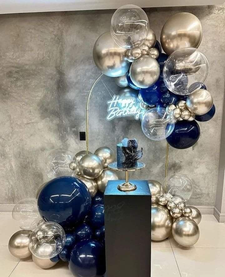 blue and silver balloons are on display in a room