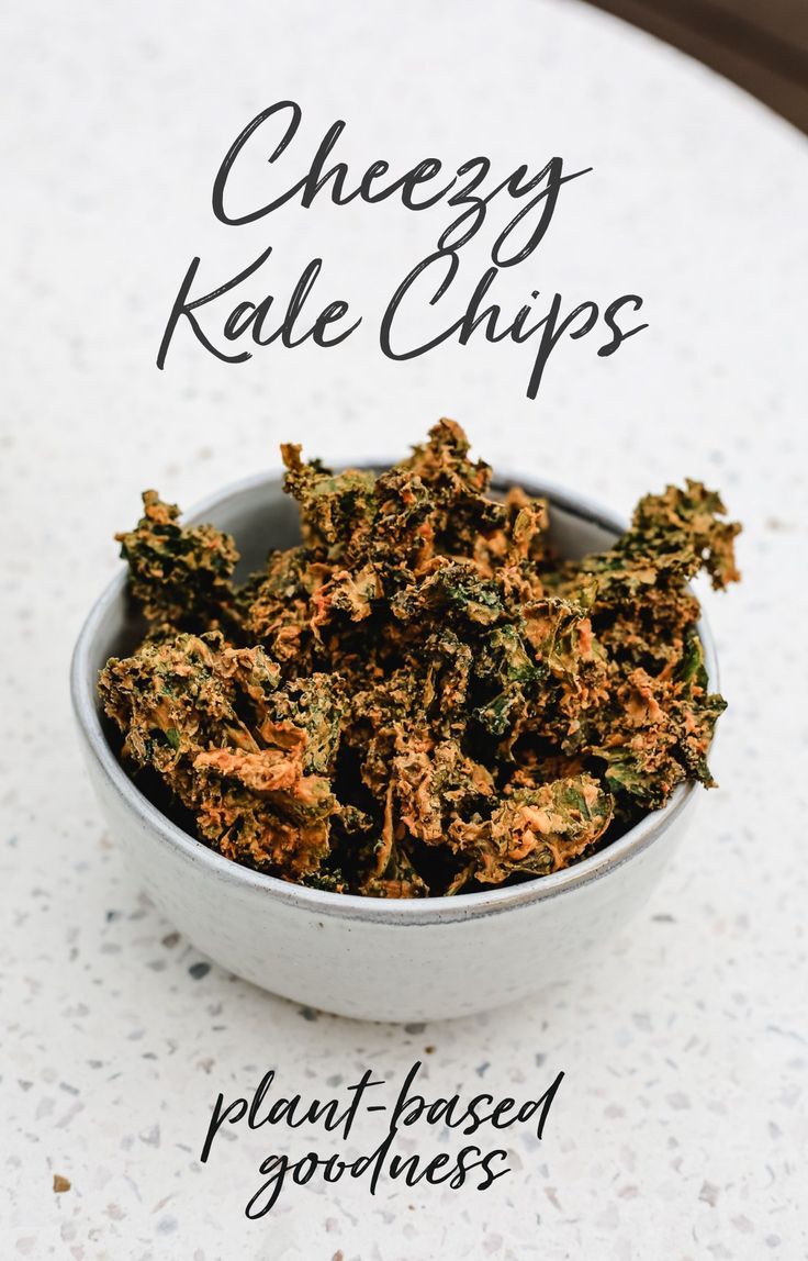 cheesy kale chips in a bowl on a table with the title above it