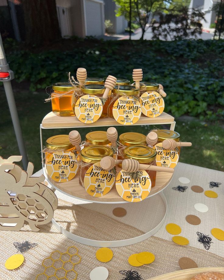 a table topped with lots of honey jars