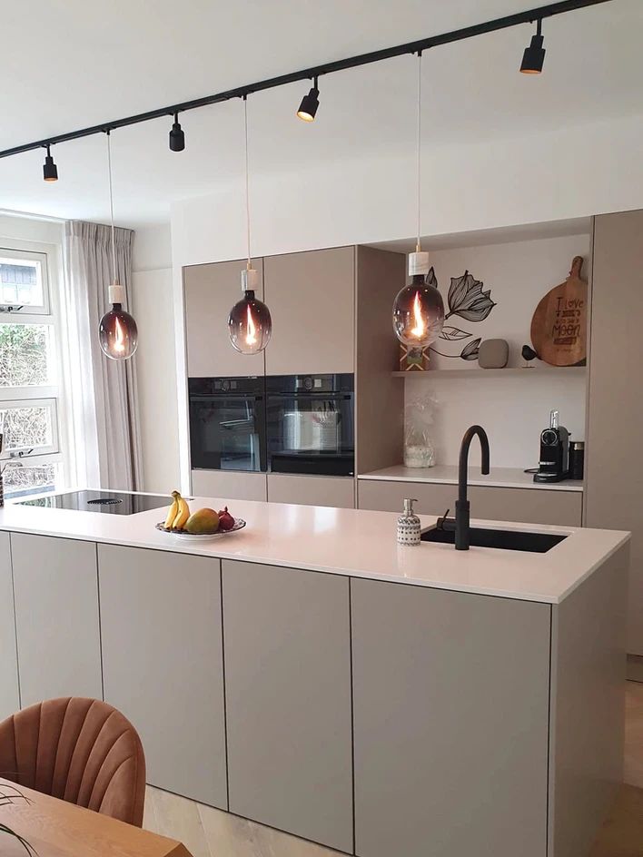 a kitchen with an island, sink and oven