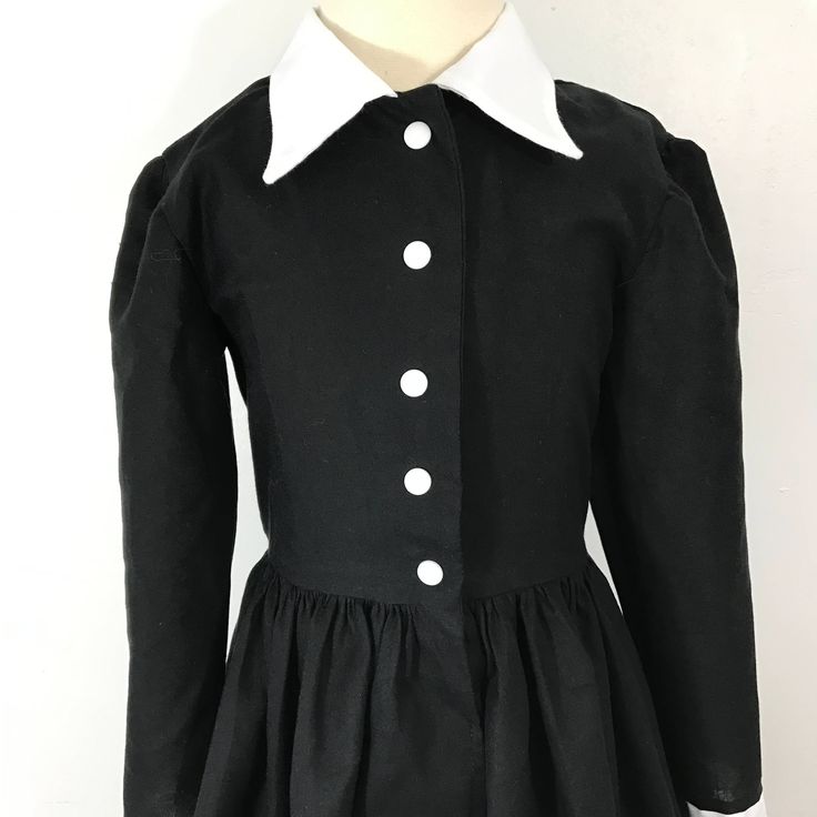 This is an adorable black shirt dress with a full skirt. I could also make it out of different fabrics, if you are looking for a custom shirt dress, message me for customization. accessories not included. This dress is perfect for Halloween Thank you for checking out my listing! Fitted Doll Collar Dress For School, Long Sleeve Cotton School Dress, Fitted Black Dress For School, Black Fitted Dress For School, Classic Black Collared Shirt Dress, Black School Dresses For Fall, Black Dresses For School In Fall, Formal Cotton Dress With Buttons, Black Fall Dresses For School