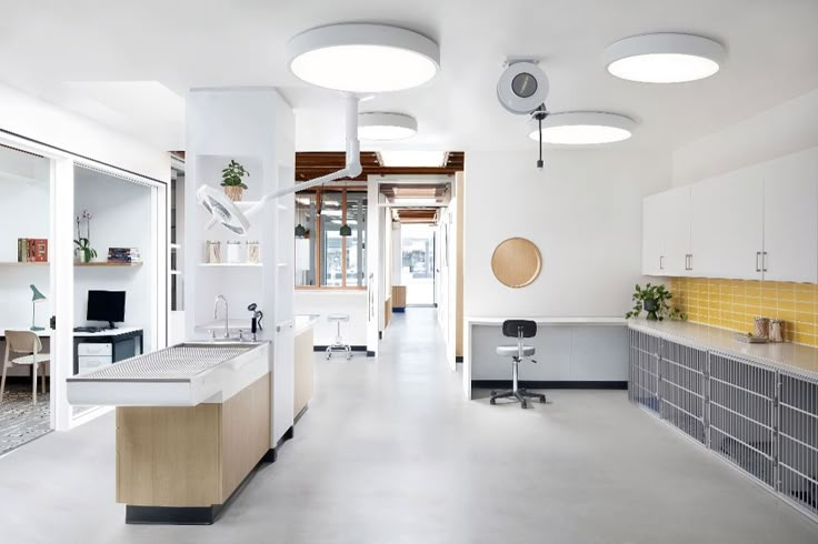 an empty room with two sinks and several lights on the ceiling in front of them