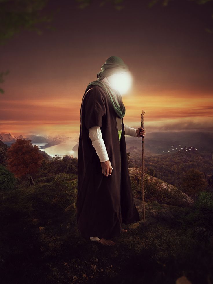 a man in a robe holding a stick on top of a hill