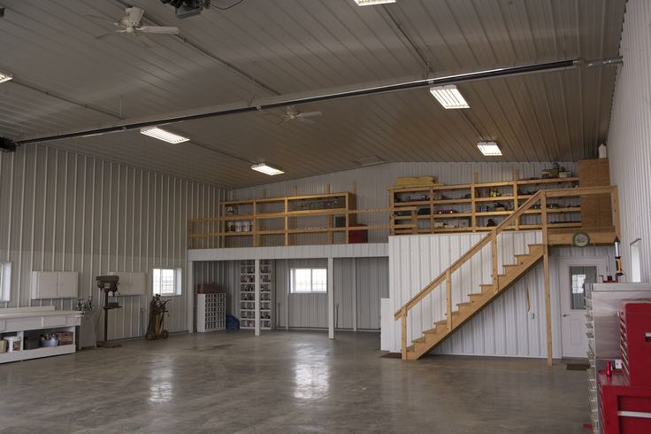 the inside of a large building with stairs and storage units on each side of the room