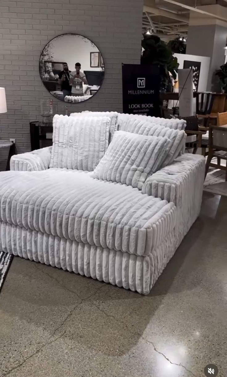 a white couch sitting on top of a hard wood floor