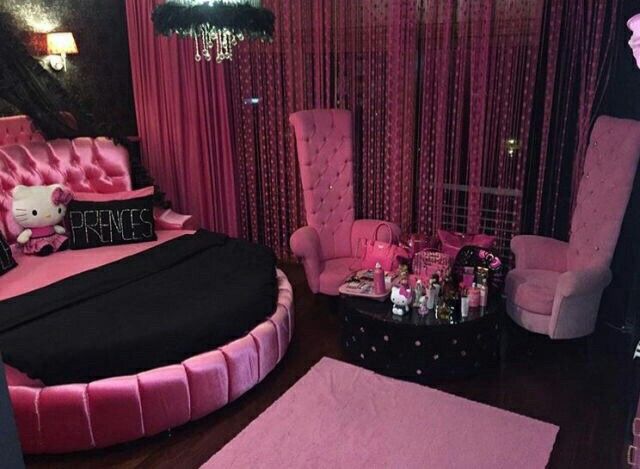 a hello kitty themed bedroom with pink and black furniture, chandelier, rugs, and curtains