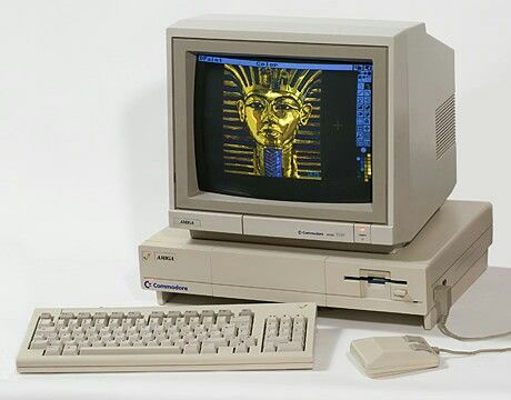 an old computer with a keyboard, mouse and monitor sitting on a white table top