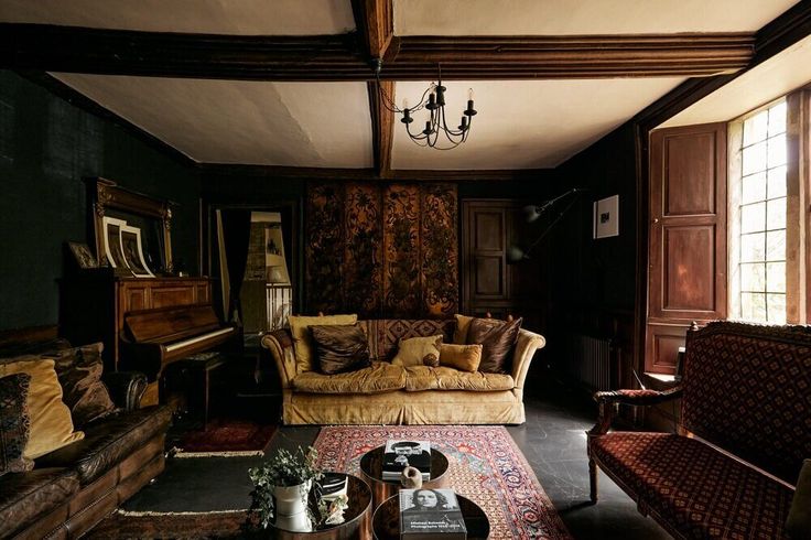 a living room filled with furniture and a chandelier hanging from it's ceiling