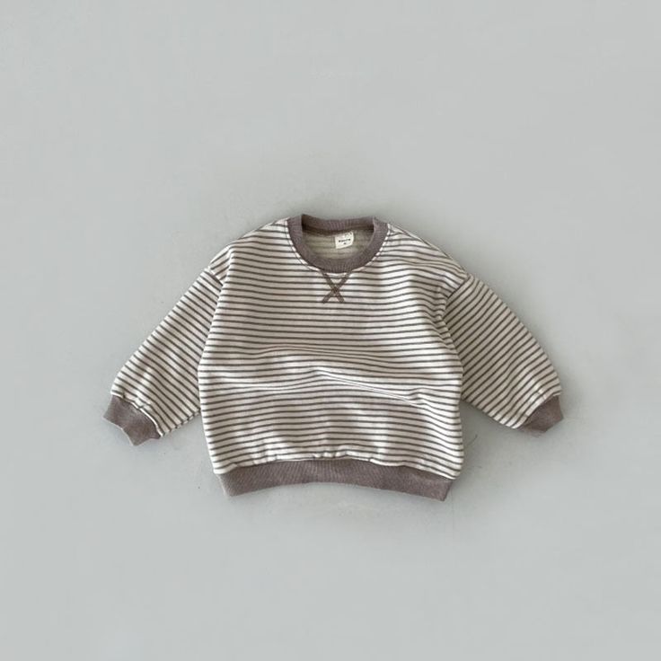 This lovely sweatshirt is an ideal choice for your little ones to wear during the pleasant spring and autumn seasons. It features a relaxed and casual style, with regular sleeves and a charming striped pattern crafted from soft and breathable cotton material. The neck and head area are thoughtfully designed without any pullcords, and the collar is a comfortable O-neck style. This piece is suitable for both boys and girls and is available in true-to-size measurements, ensuring a perfect fit for y Playful Long Sleeve Sweatshirt With Ribbed Cuffs, Cute Striped Long Sleeve Sweater, Playful Cotton Sweatshirt With Ribbed Cuffs, Playful Cotton Sweater With Ribbed Cuffs, Cute Striped Tops For Fall, Cute Striped Fall Tops, Striped Sweatshirt For Loungewear In Fall, Striped Sweatshirt For Fall Loungewear, Striped Long Sleeve Sweater For Everyday