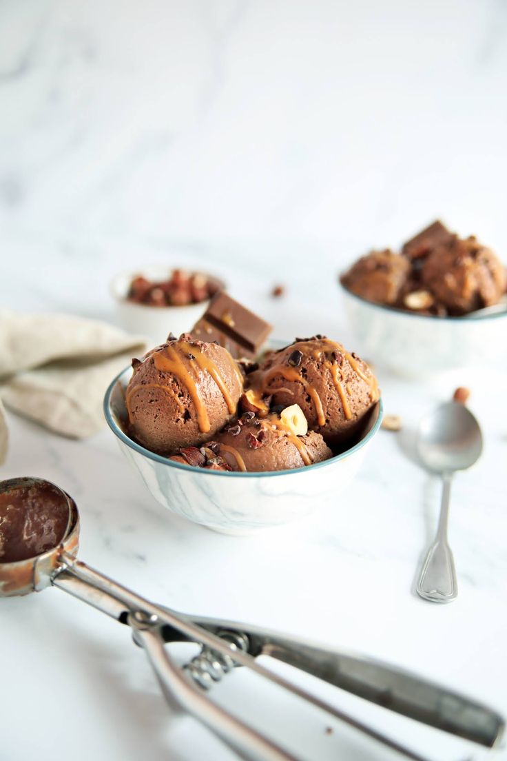 two bowls filled with chocolate ice cream and spoons