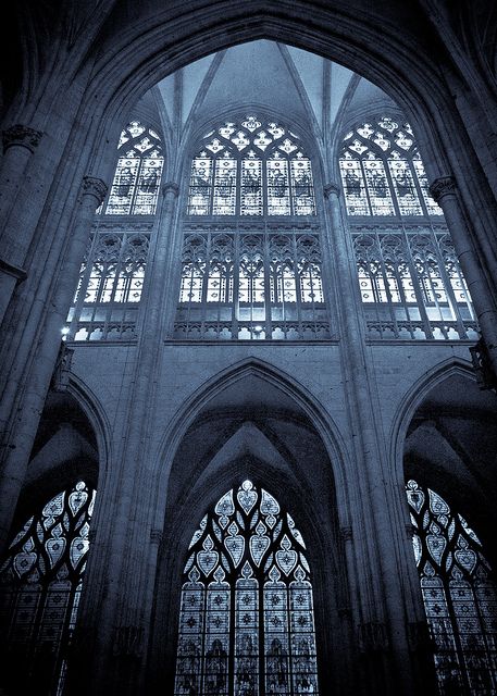 the inside of a cathedral with stained glass windows