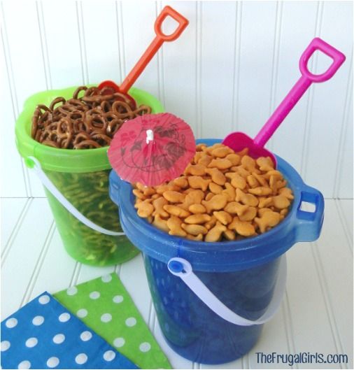 two buckets filled with cereal and an umbrella