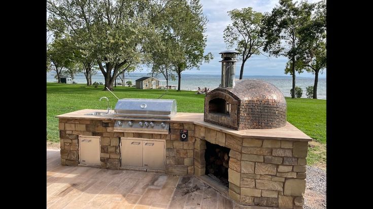 an outdoor bbq with grill and oven built into it