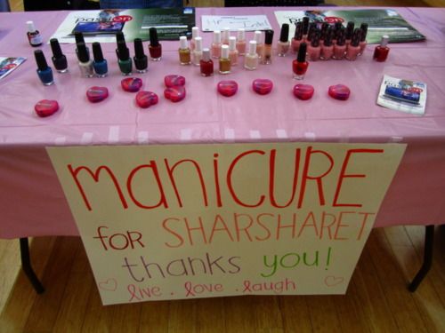 a pink table topped with lots of manicures on it's sides and a sign that says manicure for share