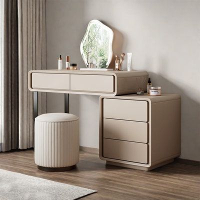 a white vanity with two drawers and a mirror on the wall next to a stool