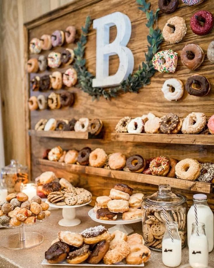 a table topped with lots of donuts and other pastries