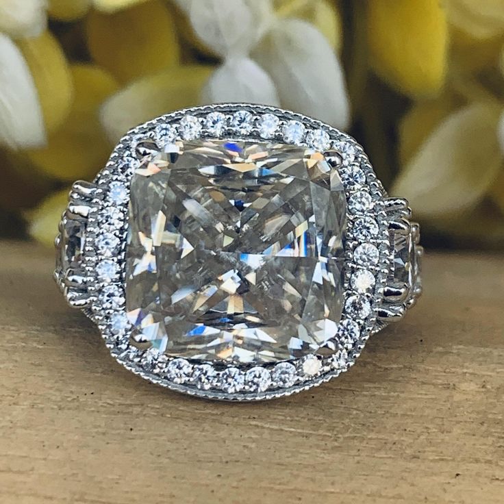 a fancy cushion cut diamond surrounded by diamonds