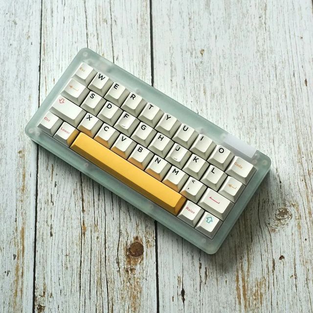 a yellow and white keyboard sitting on top of a wooden table