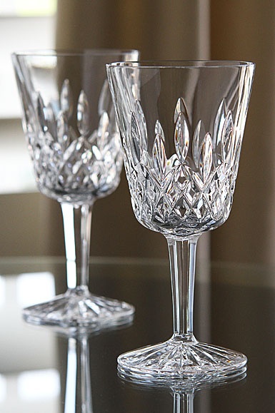 two clear wine glasses sitting on top of a table