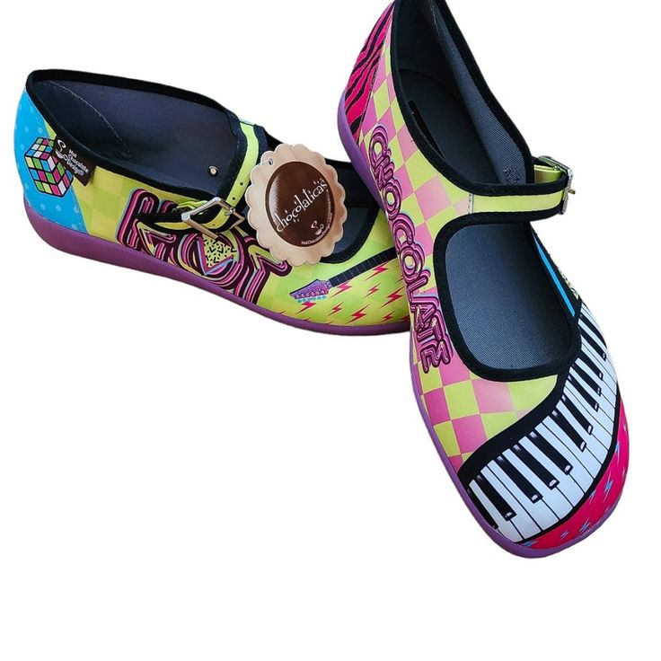 New With Tags! Collectable Chocolatics Shoes Hot Chocolate Design Mary Janes Colorful Pop Maximalist Design Rubix Cube, Keyboard, Guitar Design Printed Fabric Upper. Soft Fabric Inner Non-Marking Rubber Sole Cushioned Inner Sole For Maximum Comfort Adjustable Buckle Strap Vegan Fun Yellow Slip-on Sneakers, Yellow Flat Sneakers With Rubber Sole, Yellow Non-slip Sneakers For Summer, Yellow Non-slip Summer Sneakers, Keyboard Guitar, Hot Chocolate Design, Rubix Cube, Maximalist Design, Chocolate Design