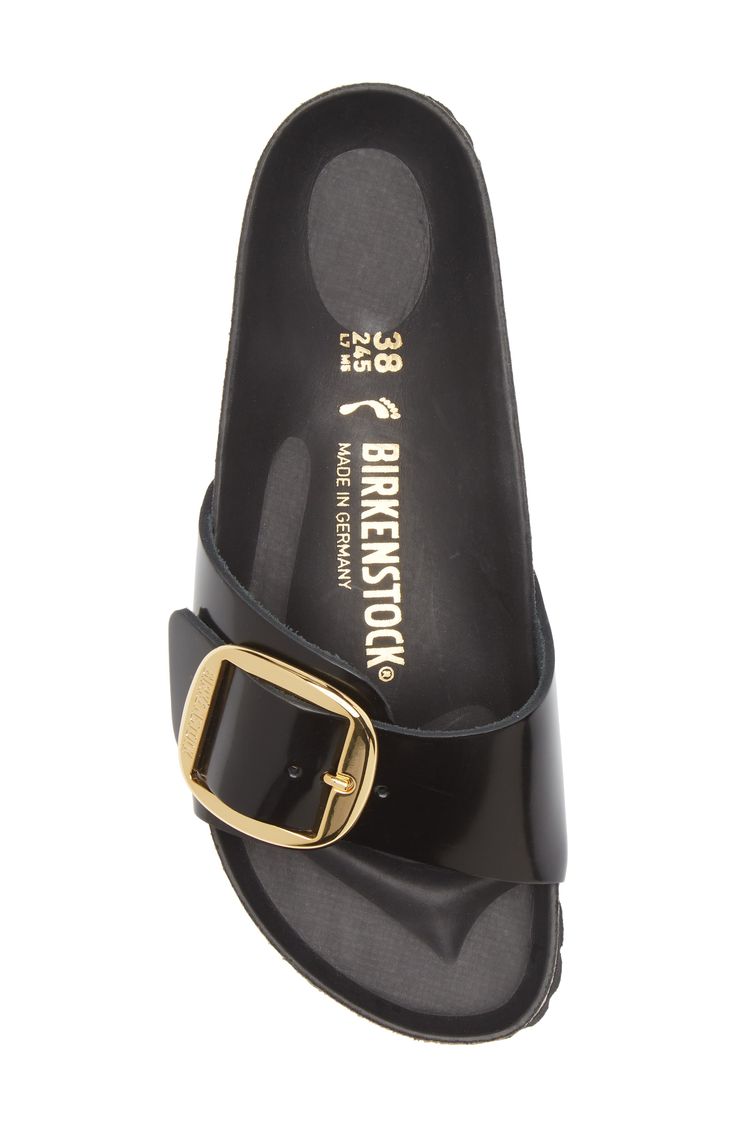 An oversized buckle cinches the angled bridge strap of a sandal built on the legendary Birkenstock footbed for time-tested comfort and on-trend style. The EVA-cushioned footbed absorbs shock and mimics the shape of a healthy foot, while pronounced medial and metatarsal arches support the instep and ball of your foot. Flat sole Single wide strap with large adjustable metal pin buckle Anatomically shaped cork-latex footbed Leather upper and lining/synthetic sole Imported Madrid Big Buckle, Birkenstock Madrid Big Buckle, Single Wide, Birkenstock Madrid, Wide Straps, Arch Support, Birkenstock, Madrid, Adjustable Straps