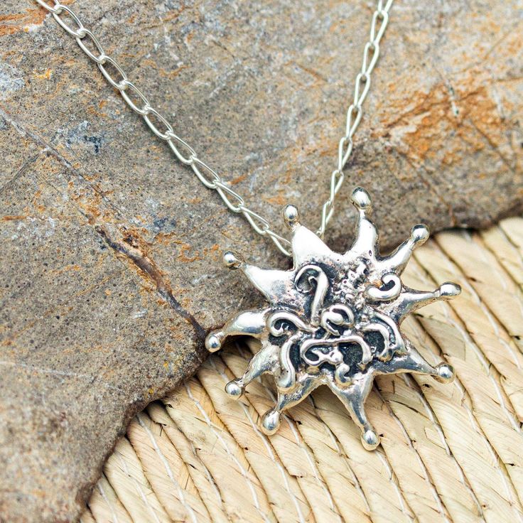 This sterling silver pendant necklace seamlessly combines mythological imagery from both the Old and New Worlds. The base is a sun design inspired by Mexico's indigenous cultures with the many snakes of Medusa's head superimposed and outlined by oxidation. It meets with the many snakes of Medusa's head superimposed and outlined by oxidation in a creation by Mexican craftswoman Rosa Rojo.