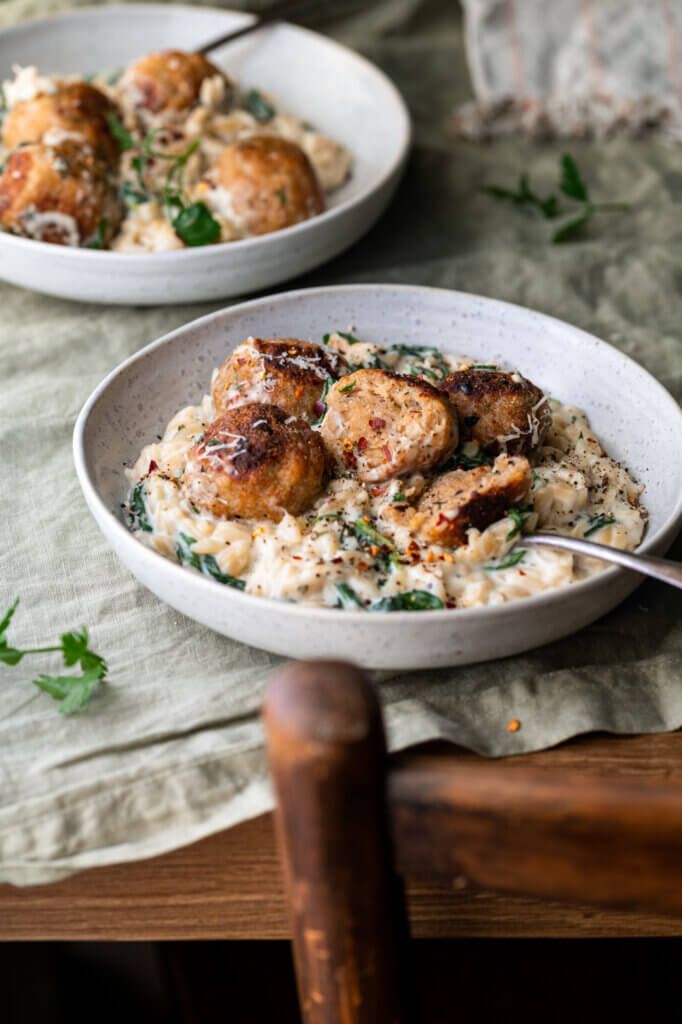 two white bowls filled with food on top of a table