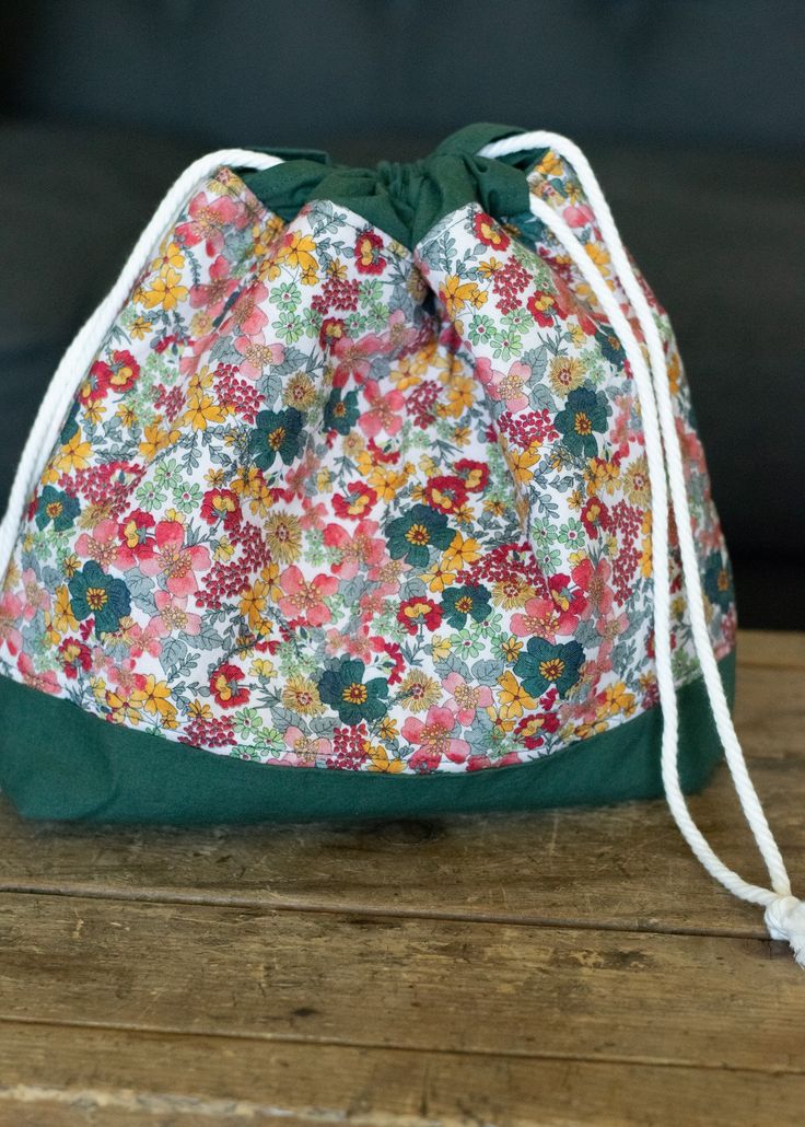 a drawstring bag sitting on top of a wooden table