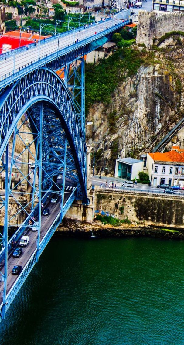 an aerial view of a blue bridge over water