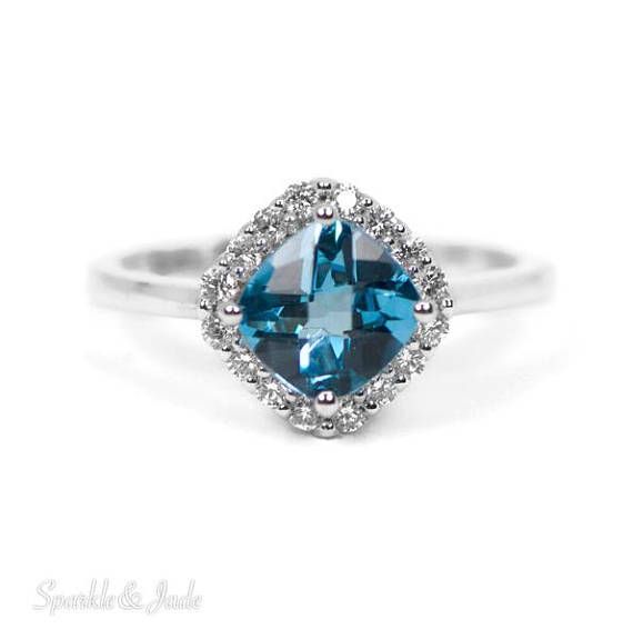 a blue topazte and diamond ring in white gold with diamonds around the band