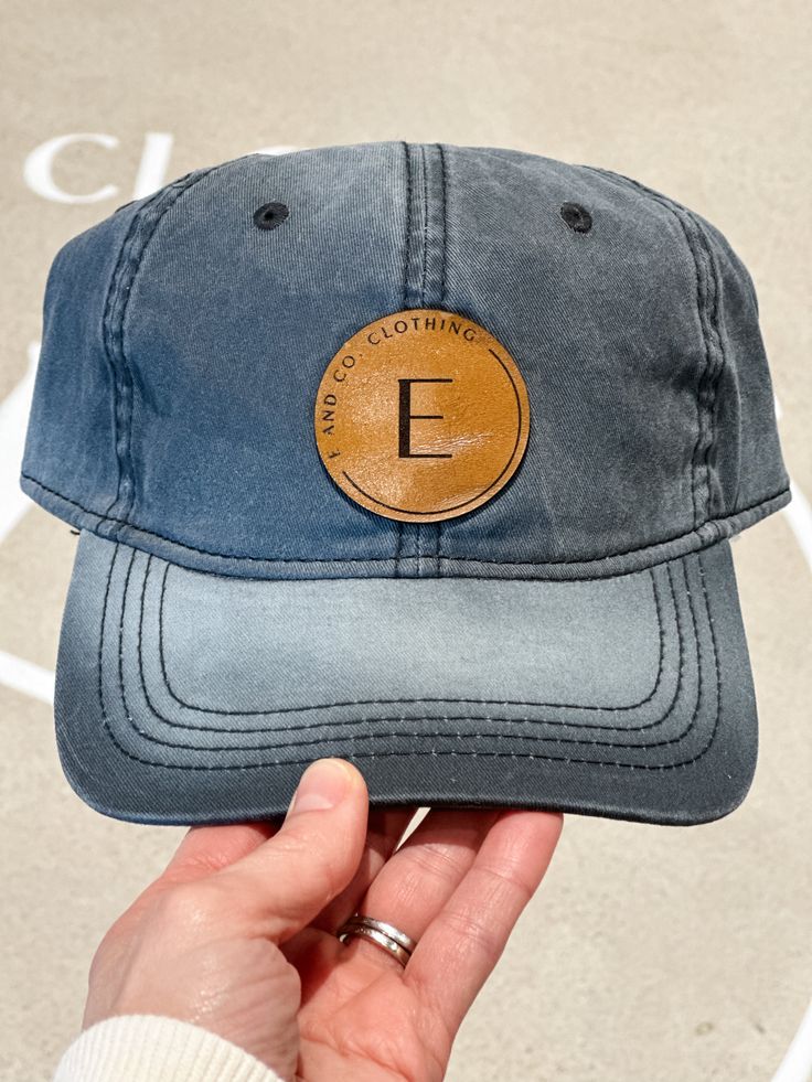 Women's Acid Washed Adjustable Baseball Cap E AND CO. CLOTHING BASEBALL CAP Introducing the E and Co. Baseball Cap: the perfect blend of signature style and casual comfort for all your summer days. Show off your love for the brand while staying cool and stylish. Upgrade your look with this must-have accessory. Take a look at our other hats and accessories HERE! Details One size Women's Acid Washed Adjustable Baseball Cap Color option: Black Acid Wash Leather patch Adjustable 100% Cotton Hats are Co Clothing, Square Logo, Round Logo, Leather Patches, Ball Cap, Acid Wash, Signature Style, Summer Days, Clothing Items