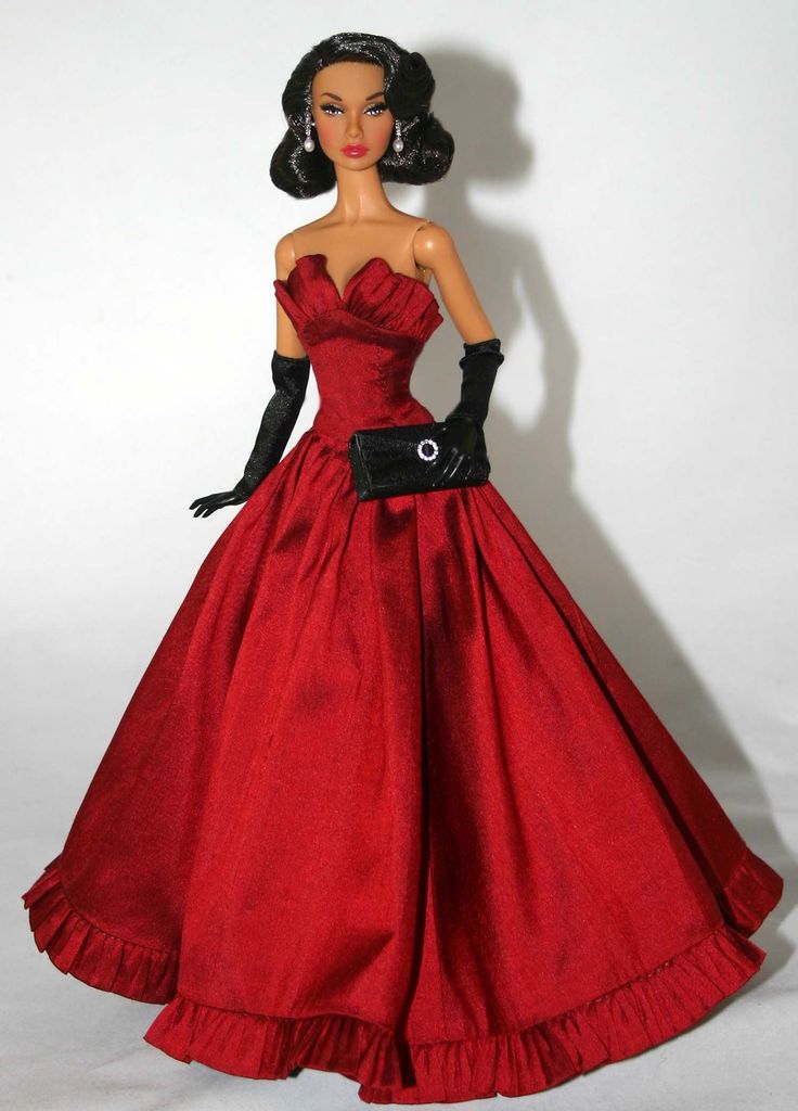 a barbie doll wearing a red dress and black gloves with her hand on her hip