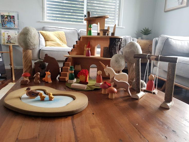 a wooden table topped with lots of toys