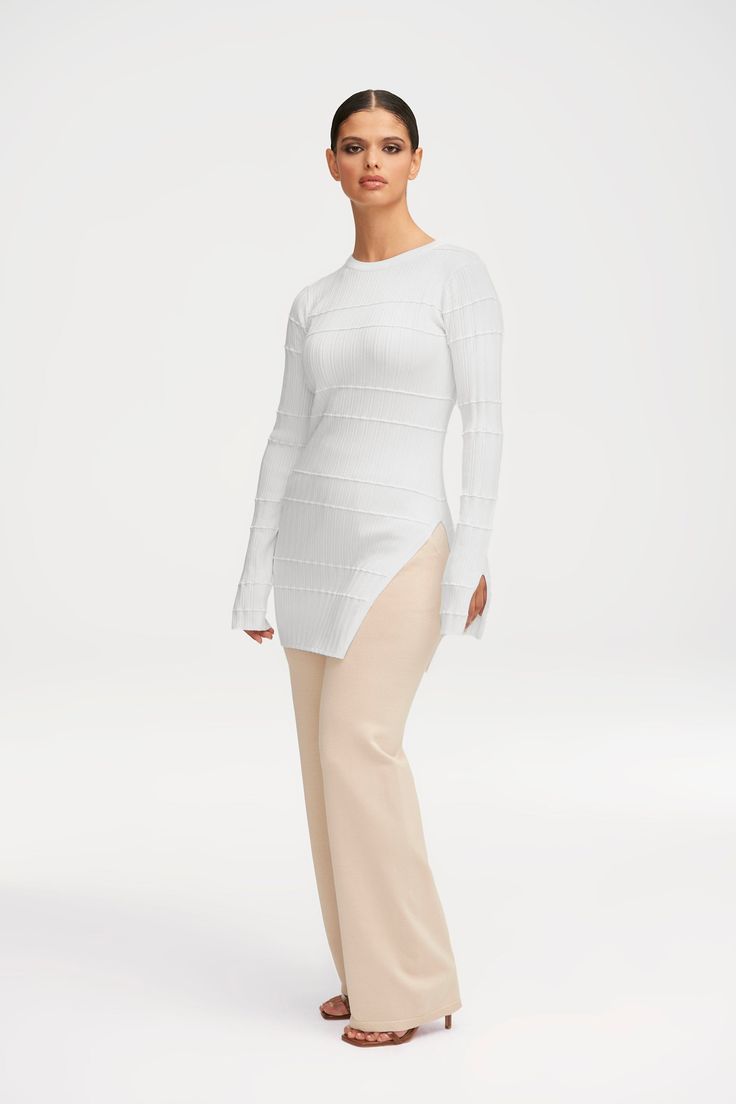 Elevate your basics with our Milano Ribbed Knit Split Hem Top in White. The unique knit rib creates a striped texture, while the split hem and cuffs add a modern flair. Perfect for a sophisticated and exclusive look. Model is 5'6 and is wearing size S. Hem Top, Split Hem, Ribbed Knit, Split, Texture, Knitting, How To Wear, White