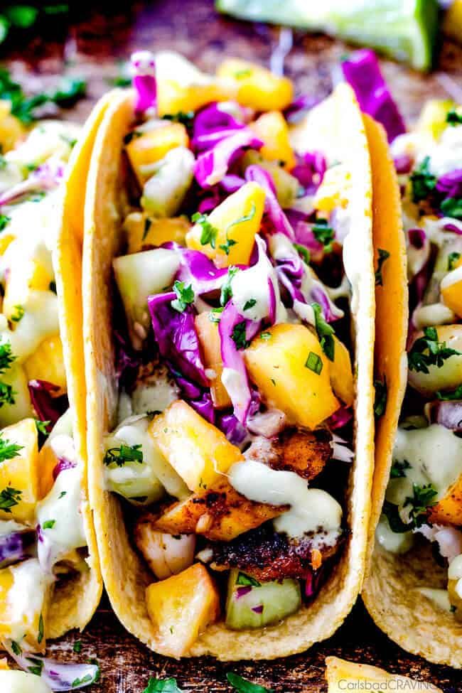 three tacos filled with coleslaw, chicken and pineapple slaw dressing