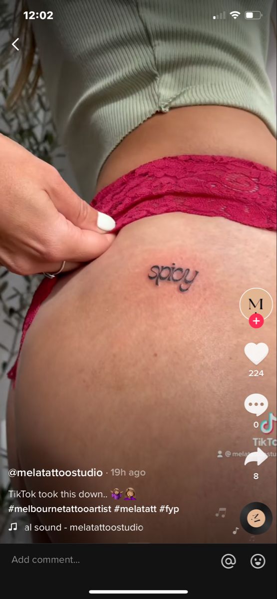 a woman's stomach with the word baby tattooed on her belly and other small tattoos