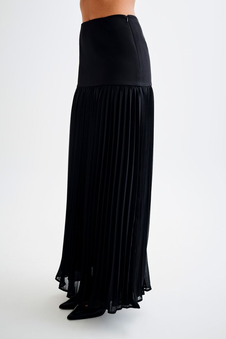 Going with the flow.The JILLIAN Pleated Maxi Skirt is a sophisticated and elegant addition to any wardrobe. This high-waisted skirt features a fitted yoke that transitions into a beautifully pleated chiffon lower skirt, offering a graceful flow and movement. With its maxi length, it exudes timeless charm. Pair it with the Letitia Suiting Halter Top with Buckle for a chic and polished ensemble. Evening Pleated Voluminous Maxi Skirt, Pleated Chiffon Tiered Maxi Skirt, Chic Pleated Chiffon Skirt, Fitted Pleated Maxi Skirt For Party, Fitted Tiered Maxi Skirt With Pleated Waist, Elegant Flowy Maxi Skirt With Accordion Pleats, Voluminous Skirt With Pleated Hem For Party, Flowy Tiered Skirt For Evening, Elegant Chiffon Midi Pleated Skirt