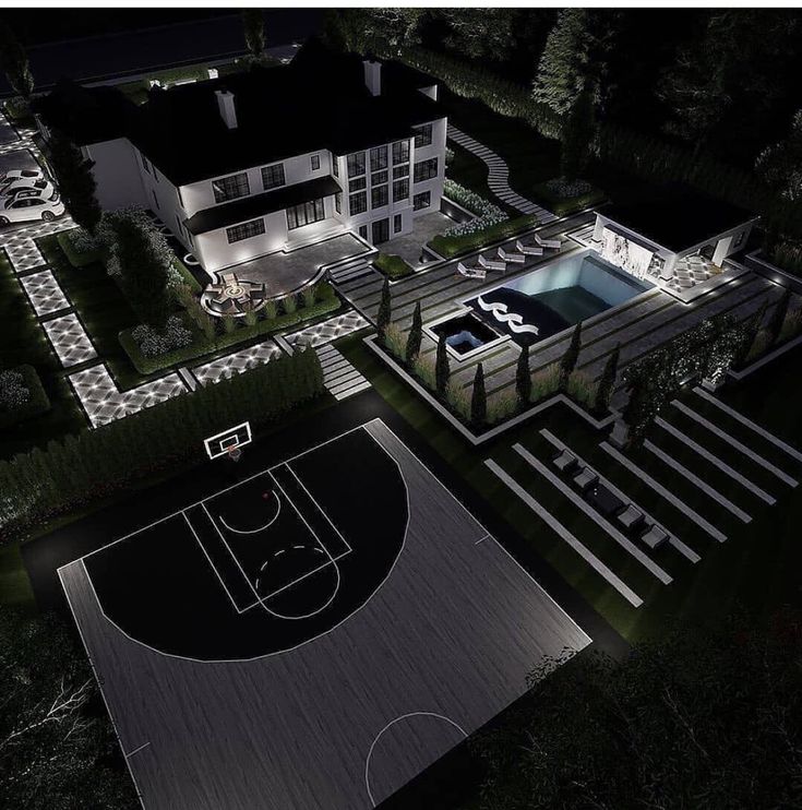 an aerial view of a basketball court at night with lights on and in the ground