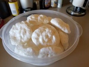 a plastic container filled with food on top of a table