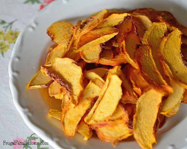 a white bowl filled with potato chips on top of a table