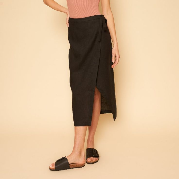 The Valentina Skirt Is A Linen Mid-Length Wrap Skirt. Black Lined Relaxed Skirt Bottoms, Black Skirt For Summer Day Out, Summer Black Relaxed Skirt, Black Long Lined Skirt, Black High Waist Pencil Skirt For Summer, High Waist Black Pencil Skirt For Summer, Black Summer Pencil Skirt, Versatile Black Asymmetrical Skirt, Chic Black Asymmetrical Wrap Skirt