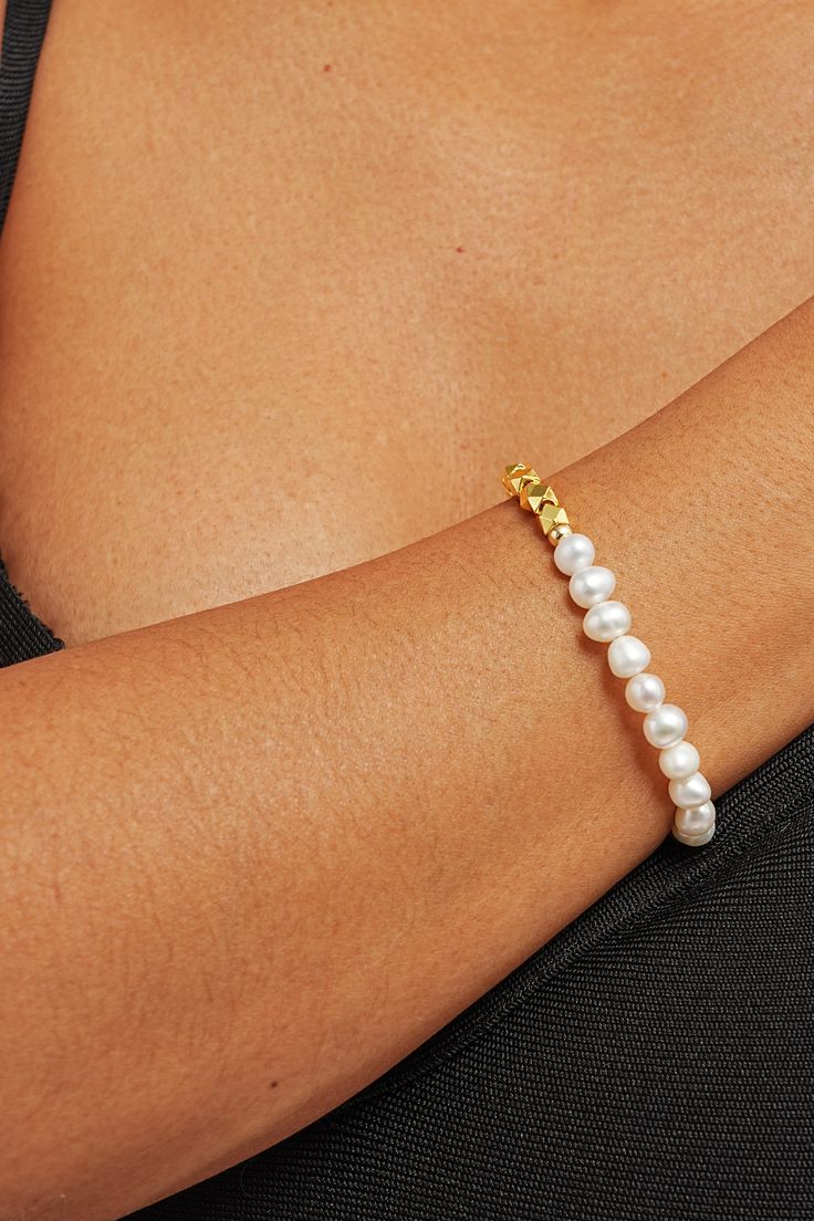 Elevate your wrist game with our Zarina Pearl Mix Bracelet – a stunning blend of pearls and gems crafted to adorn your wrist with timeless elegance. Picture yourself effortlessly commanding attention at every turn, your wrist adorned with lustrous pearls and shimmering gems, a symbol of your unique style and sophistication. Embrace the power of femininity with every flick of your wrist as this bracelet whispers tales of timeless beauty and grace. Pearl Embellished Bracelet Jewelry Gift, Pearl Embellished Jewelry Bracelet Gift, Gift Pearl Embellished Jewelry Bracelet, Pearl Bracelets With Round Beads And Charm, Pearl Chain Bangle Bracelets, Pearl Bangle Bracelet With Pearl Chain, Pearl White Bracelet With Pearl Chain, Pearl Drop Bracelet Jewelry, Minimalist Pearl Jewelry With Oyster Bracelet