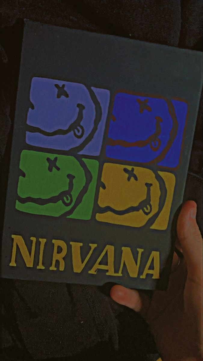 someone holding up a book with the words nirvana on it