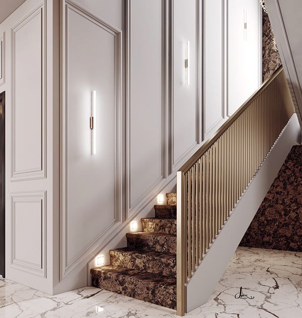 an elegant staircase leading up to the upper floor in a home with marble floors and white walls