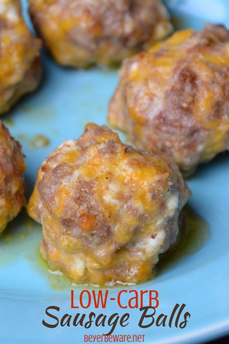 several cheese balls on a blue plate with the words low - carb sausage balls