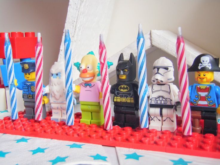 legos are lined up on a table with candles in the shape of stars and stripes