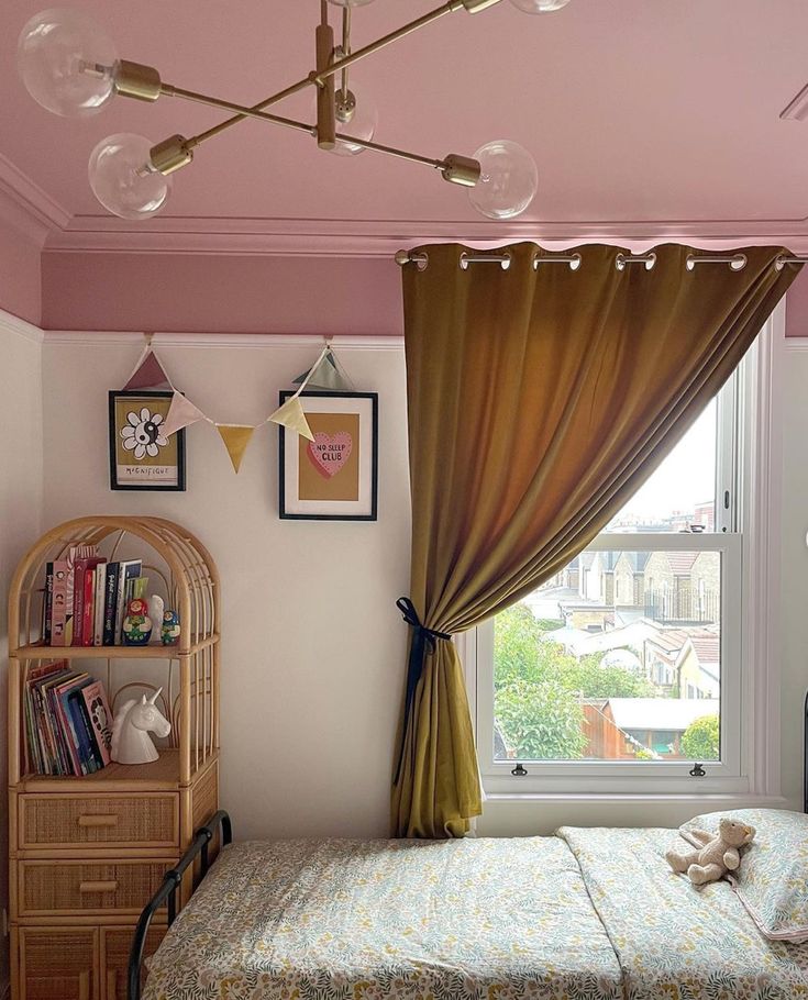 a bed room with a neatly made bed next to a window and a book shelf