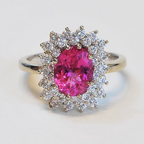 ... ORIGINAL PRICE $2950.00, SALE PRICE $1475.00...This stunning handmade oval pink tourmaline and diamond ring is set in 14k white gold. This ring sparkles a great deal making this a beautiful piece. The two rows of diamonds around the pink tourmaline make for a generous frame that fits this stone magnificently and really shows off its brilliant pink color. This ring would make for a great engagement ring, or right hand ring. Pink Tourmaline: 1.87ct32 Round Brilliant Diamonds: 1 ct VS/G-HRing S Pink Tourmaline Engagement Ring, Jewelry Knowledge, Right Hand Ring, Modern Jewellery, Etsy Gold Ring, Sparkling Rings, Tourmaline Ring, Pink Gemstones, Bling Rings