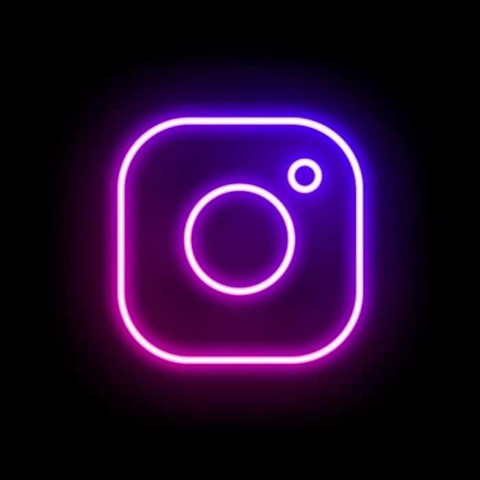 the instagram logo is glowing purple in this dark background, it appears to be an instagram button