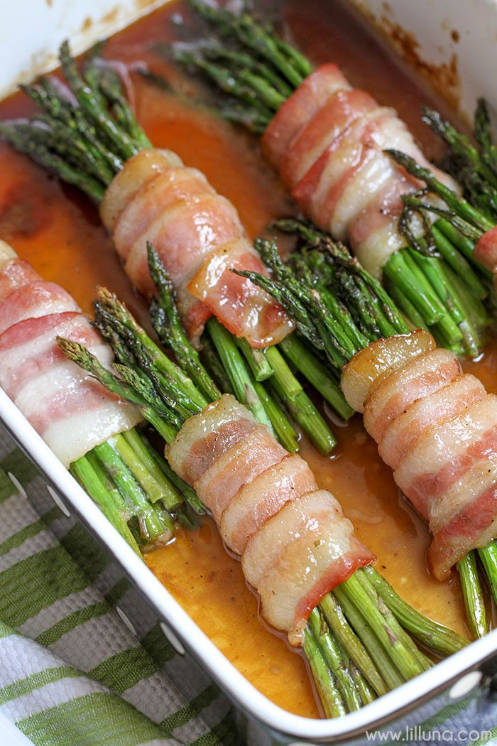 bacon wrapped asparagus bundles in a casserole dish